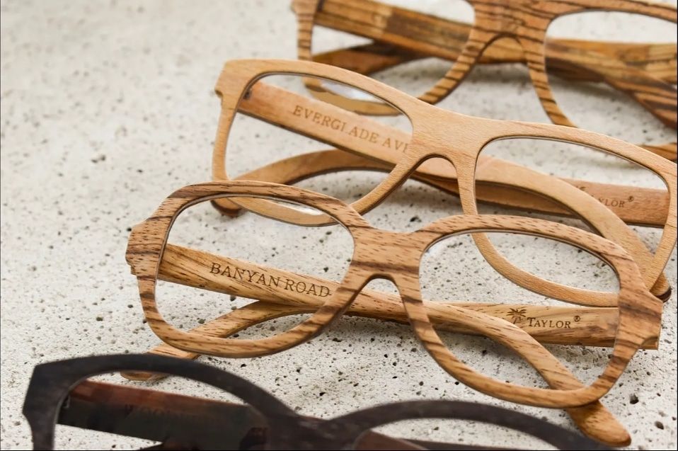 Wooden Harvey Taylor eyewear frames arranged on a stone surface